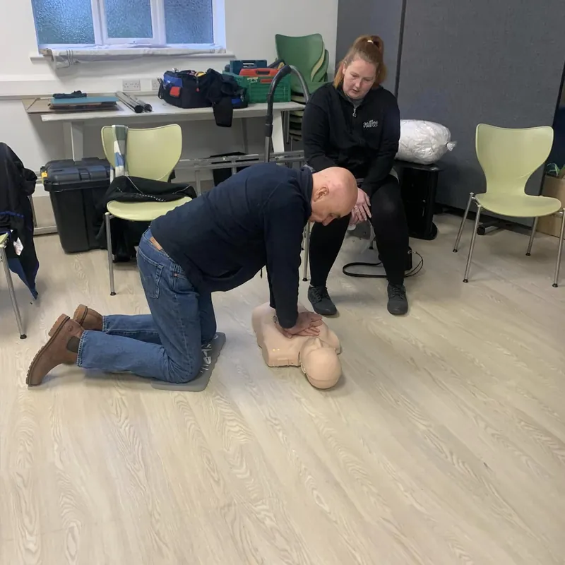 Practising chest compressions on an adult manikin
