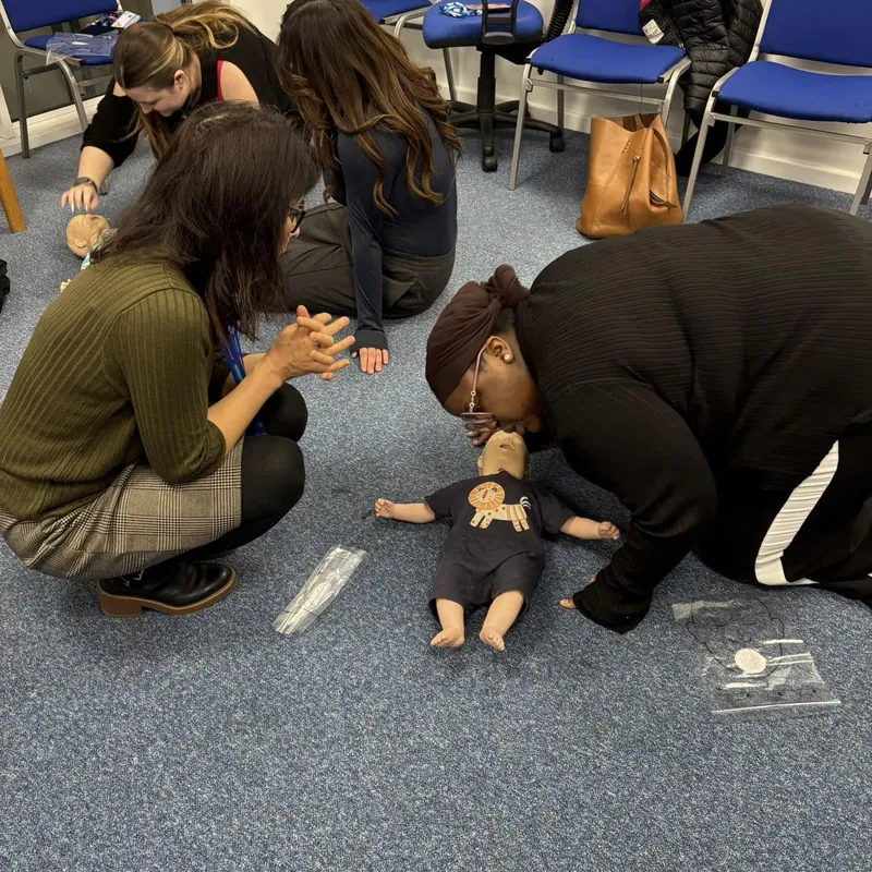 Practising first aid on an infant manikin