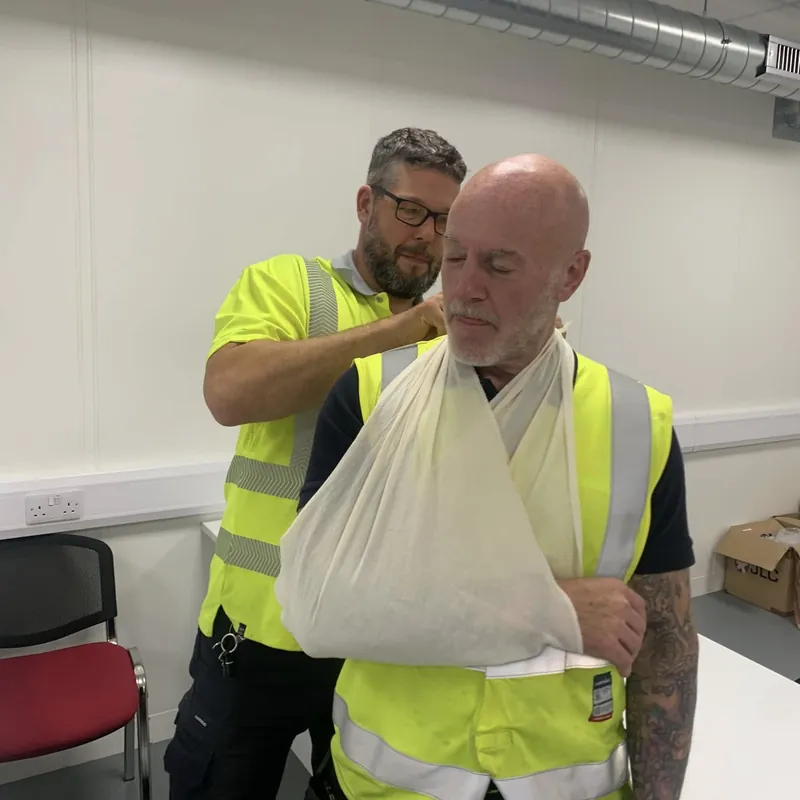 Putting an arm in a sling on a workplace course