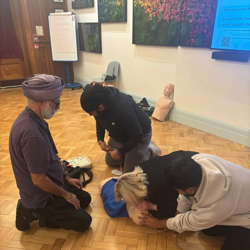 Working together on a CPR manikin with the AED trainer ready