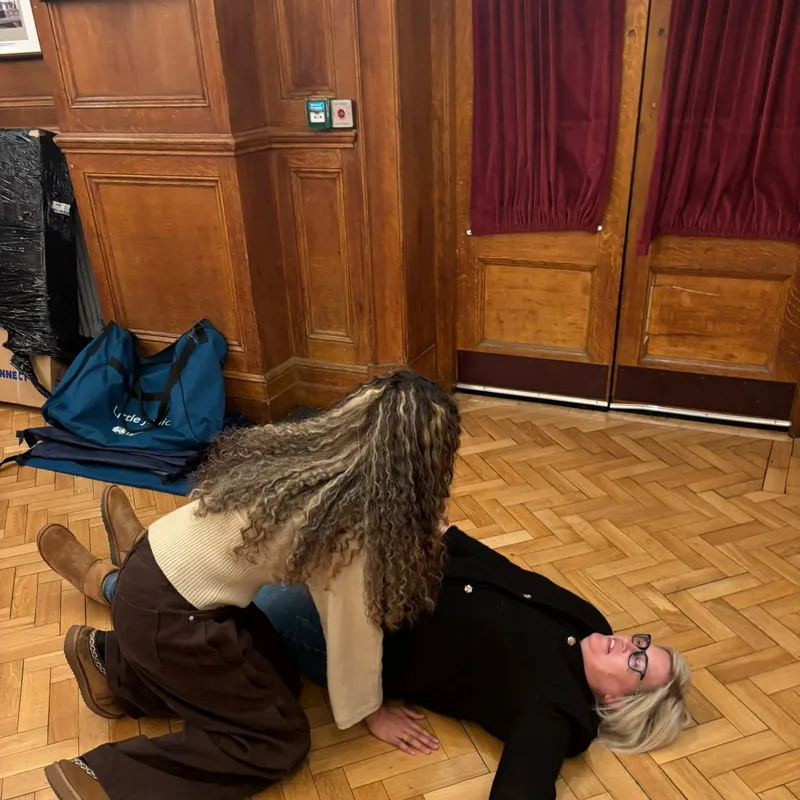 Rolling a volunteer casualty into the recovery position