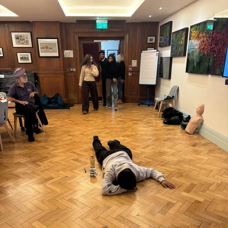 A volunteer lying face down as the casualty in a practical scenario