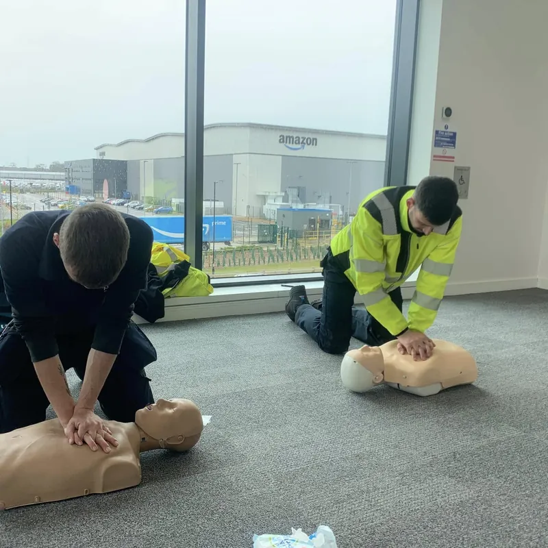 CPR practice on adult manikins in a workplace training room