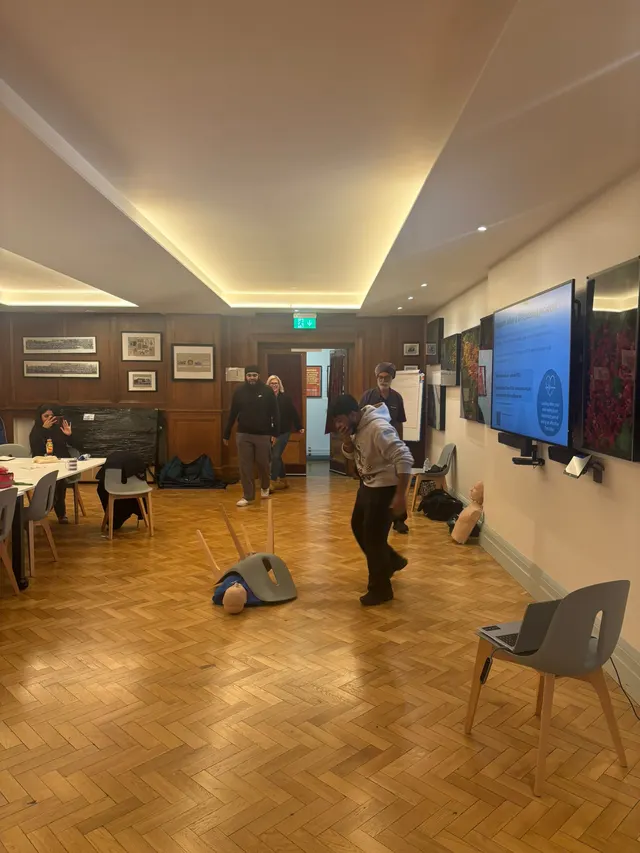 A training manikin on the hall floor set up for a practical scenario