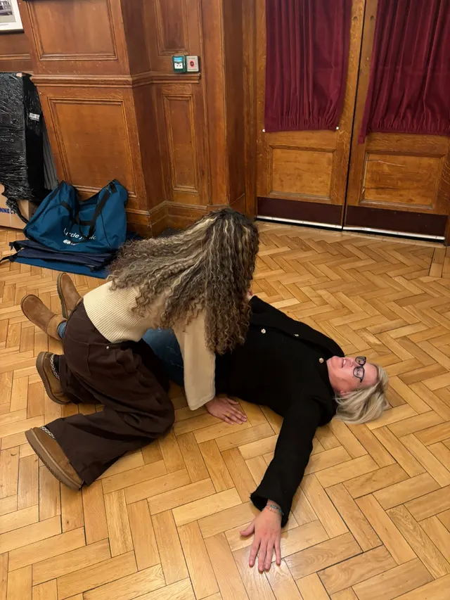 Rolling a volunteer casualty into the recovery position