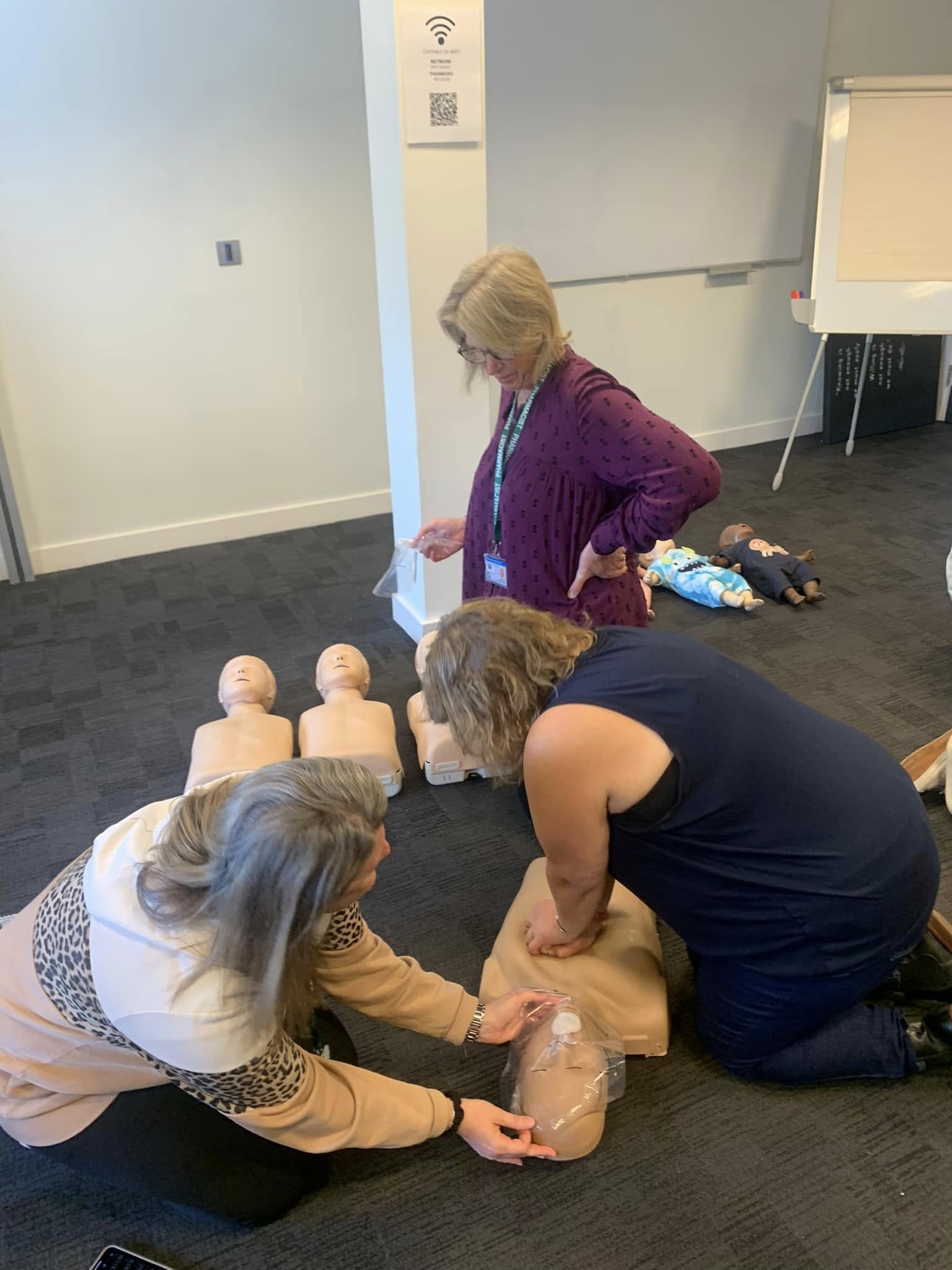 Delegates practising CPR on manikins
